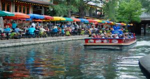 People on a small ferry boat on the river walk in San Antonio, TX