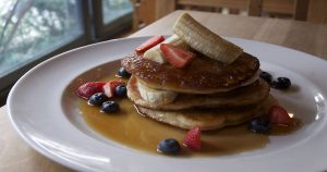 Pancakes with bananas and berries and syrup. | San Antonio. TX