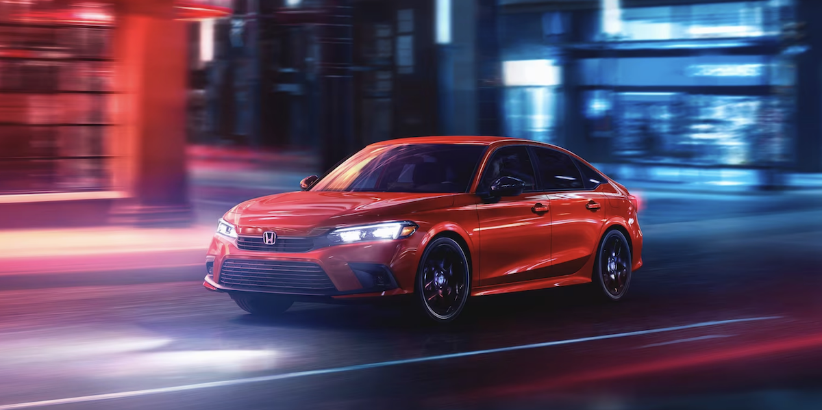 Angled photo of 2024 Honda Civic Sedan driving through city