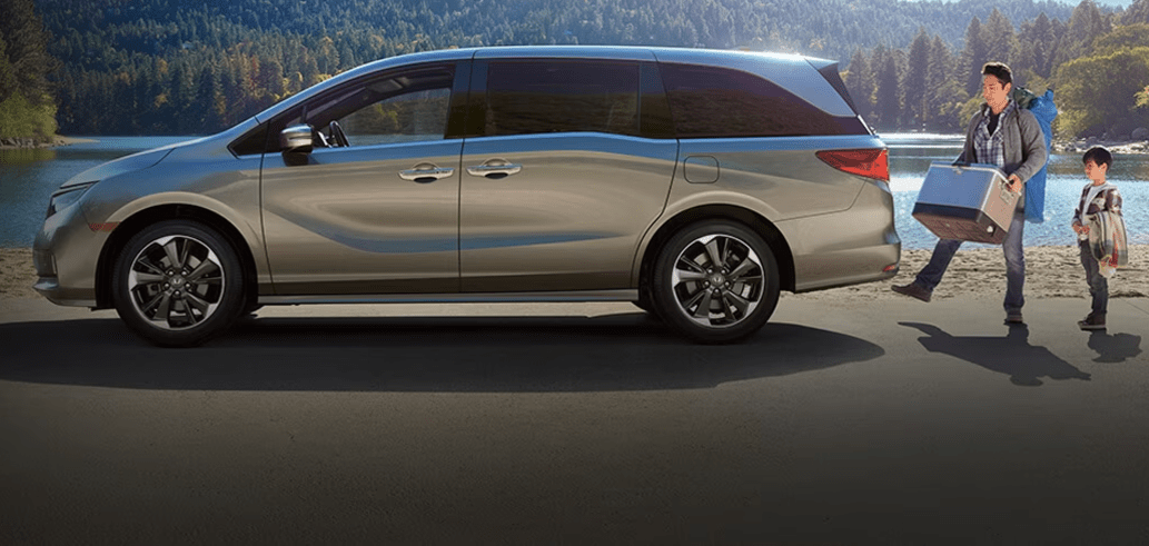 2024 Honda Odyssey with man and child standing outside