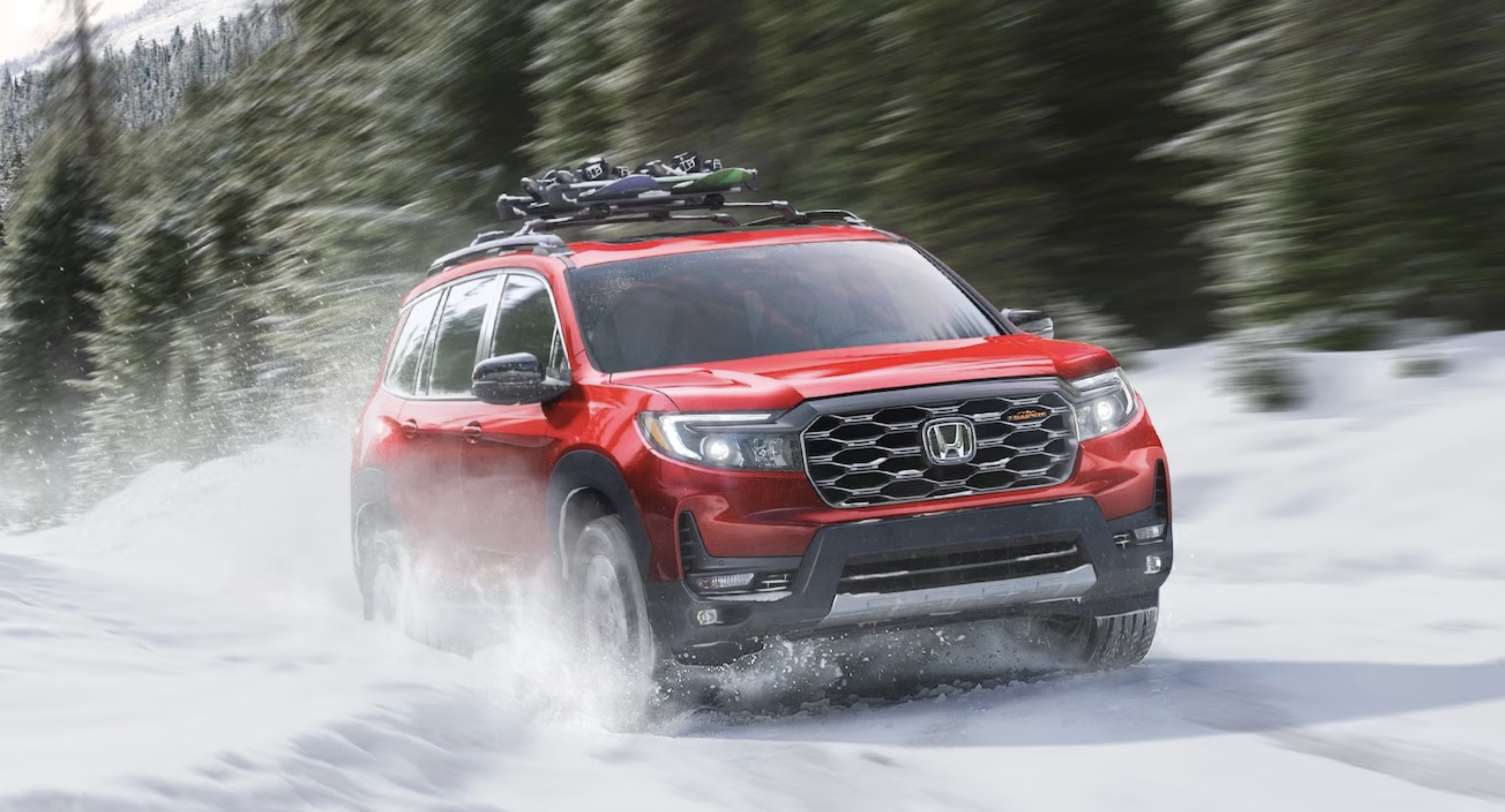 2024 Honda Passport driving through the snow