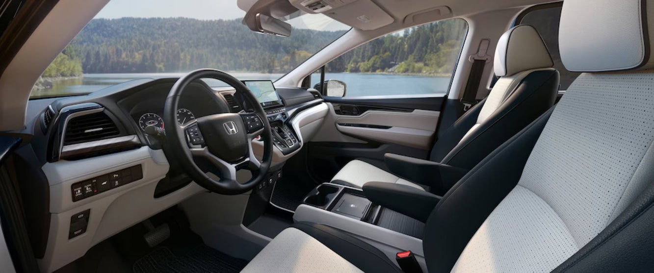 The front seats of the 2026 Honda Odyssey, featuring cream and black upholstery