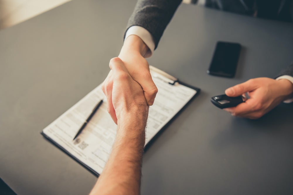 Shaking Hand After Choosing Finance or Leasing Deal