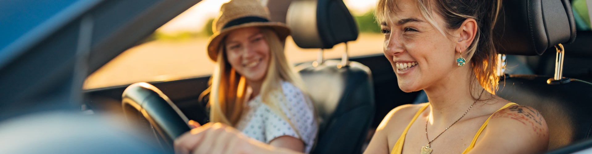 First time buyer driving with her friend